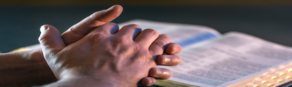 Hands near open bible